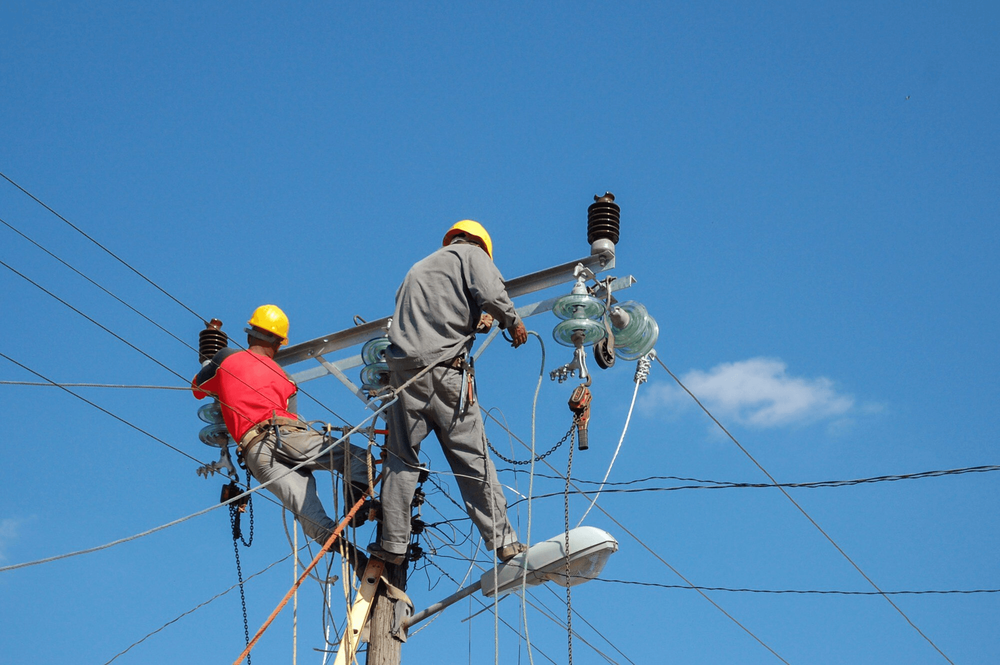 Electricians working on power lines